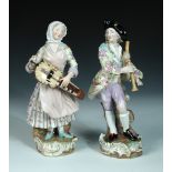 A pair of late 19th century Meissen figures of musicians, after J J Kaendler, they stand on Rococo