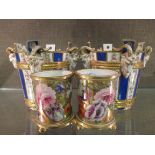 A pair of Paris 'Sevres' blue and white striped bucket planters with goat mask handles and a pair of