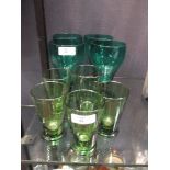 Four green glass goblets, together with four water glasses and another