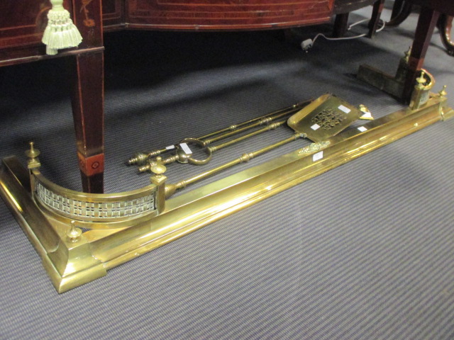 A George III brass fire irons, poker rest and a curb (5)