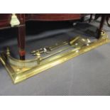 A George III brass fire irons, poker rest and a curb (5)