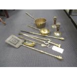A quantity of brass fire irons, a pair of candlesticks, brass pan etc