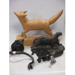 An Art Deco style wooden figure of a fox, together with four other metal animal figures
