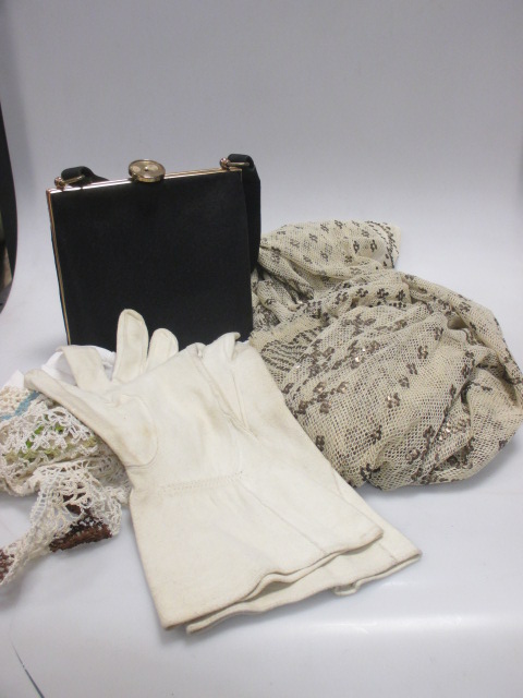 A collection of ladies evening gloves, bags and lace