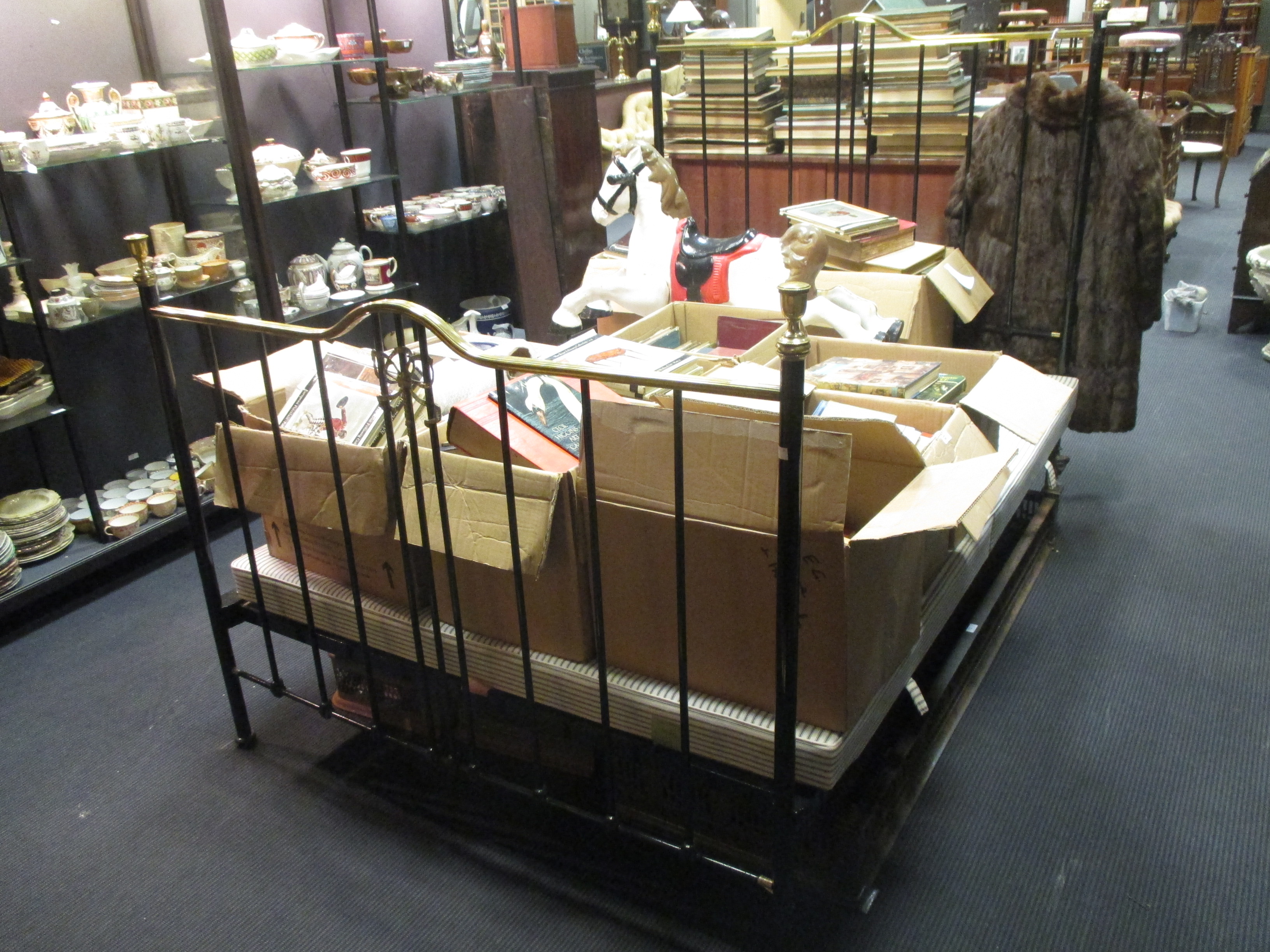 A cast iron and brass bed with base