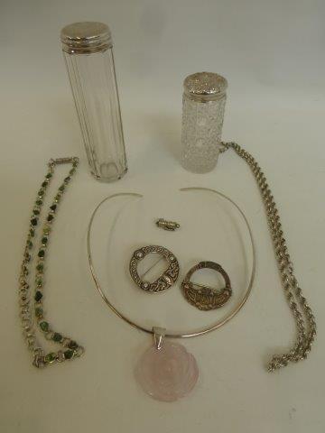 An assortment of silver jewellery including two silver topped hairpin jars.