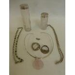 An assortment of silver jewellery including two silver topped hairpin jars.