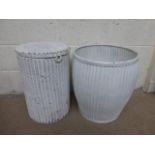 A cylindrical lidded Lloyd loom style basket and a painted metal waste bin.