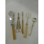 An assortment of silver plated serving flatware including a pair of sandwich servers.