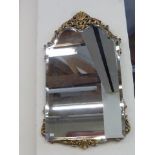 A gilt bevel edged wall mirror with pierced decoration.