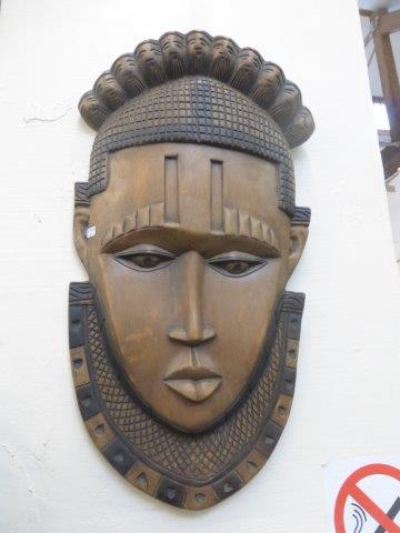 A large carved wooden nature wall plaque in the form of a native man.