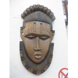 A large carved wooden nature wall plaque in the form of a native man.