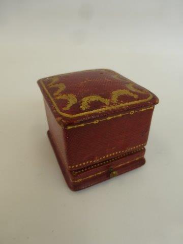 A Cartier red leather and gilded tooling ring box.