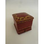 A Cartier red leather and gilded tooling ring box.