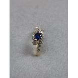 An 18ct gold sapphire and diamond ring, size O.