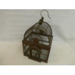 A Victorian style wooden birdcage.