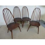 A set of four Ercol highbacked hooped dining chairs.