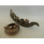 An Indian silver cruet set in a carved horn holder, with a silver ashtray.