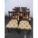 A set of six mahogany Edwardian gallery backed dining chairs with upholstered over stuffed seats,