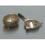 A silver tea strainer holder (unmarked) and a horn handled tea strainer.