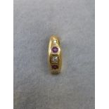 An 18ct gold ruby and diamond gypsy style ring, size I.