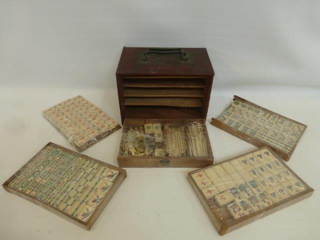 An early 20th Century majong set in a carrying box decorated with carved jade to the side panels.