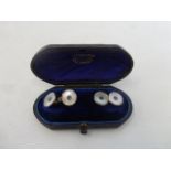 A pair of 18ct gold mother of pearl and sapphire cufflinks, cased.