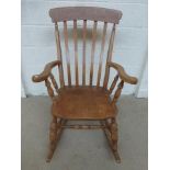 A 20th Century pine Windsor rocking chair.