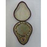 A Victorian gold (unmarked) bracelet with heart shaped locket inset with an amethyst.