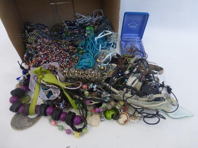 A box of assorted costume jewellery.