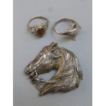 A silver and marcasite brooch in the form of a horses head, a silver dolphine ring and a silver