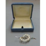 A boxed Mikimoto white gold and pearl brooch stamped 18K.