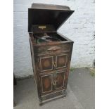 A 1930s oak cased upright gramophone with applied decoration, maker Fullotone.