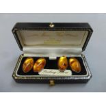 A cased pair of sterling silver and amber cufflinks, the box with retail label Murry Ward for