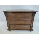 An oak and pine lined apprentice chest of three drawers, raised on bun supports.