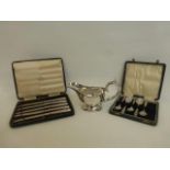 A silver plated sauce boat, a part set of teaspoons and a part set of Art Deco knives.