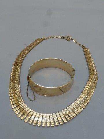 A 9ct gold and bronze core bracelet with engine turned decoration and an Egyptian style gilt