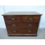 An Edwardian mahogany chest of two short over two long drawers, raised on a plinth base to castors.