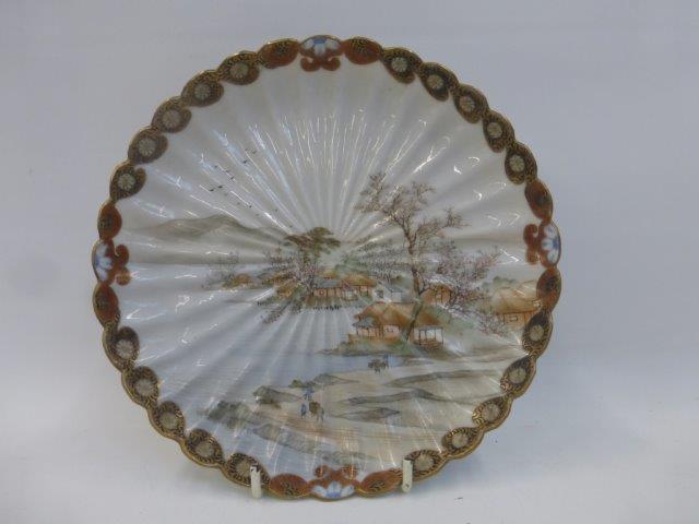 A 19th Century Japanese Satsuma ribbed dish decorated with Mount Fuji and a village in the forefont,