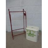 A metal stick stand and an enamel bread bin.