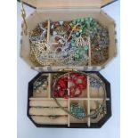 A box of assorted costume jewellery including crystal beads, brooches, rings etc.