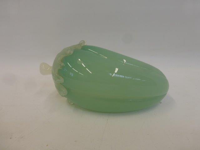 A large carved jade fruit pod.