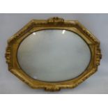 A 19th Century giltwood octagonal wall mirror with leaf border and acanthus carved decoration.