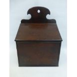 A George III mahogany wall mounted sloping fronted candle box with shaped upstand.