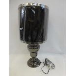 A large contemporary baluster table lamp with black pleated shade.
