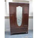 An Edwardian inlaid mahogany mirrored wardrobe with single drawer base.