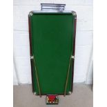 The Walter Lindrum table top snooker table with accessories.