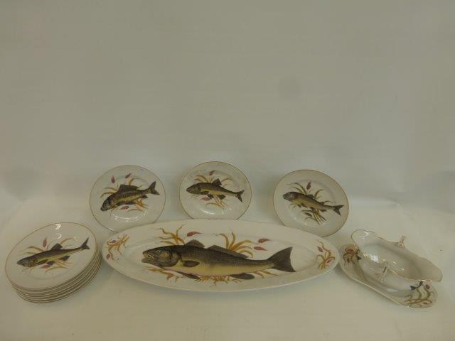 A nine setting fish sevice including a salmon plate, a sauce tureen etc.