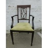 An Edwardian inlaid mahogany elbow chair with pierced spalt, raised on square tapering supports to