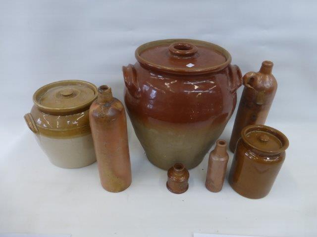 An assortment of stoneware storage jars and saltglazed flagons.